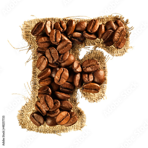 Photo: Alphabet from coffee beans on fabric texture isolated on white Alphabet from coffee beans on fabric texture isolated on white