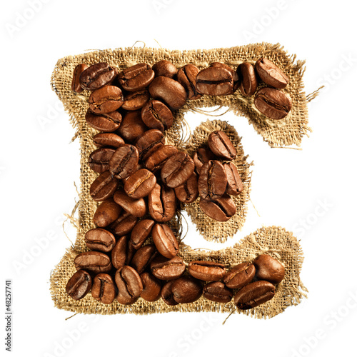 Photo: Alphabet from coffee beans on fabric texture isolated on white Alphabet from coffee beans on fabric texture isolated on white