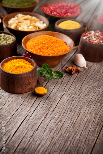 Photo: Various kind of spices in wooden bowls Various kind of spices in wooden bowls