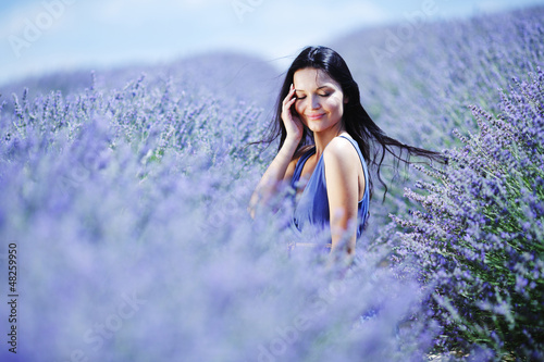 Photo: Woman sitting on a lavender field Woman sitting on a lavender field