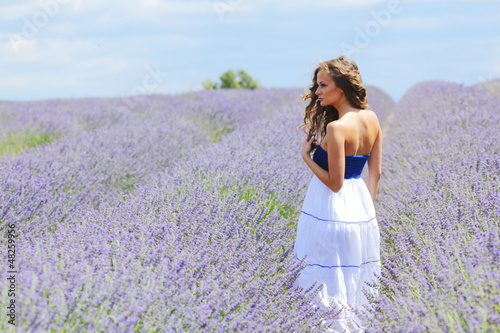 Photo: Woman standing on a lavender field Woman standing on a lavender field