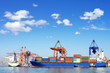 Cargo ship, containers and cranes in sea port