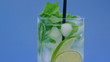Mojito cocktail closeup on blue background