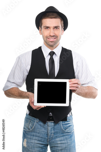 Photo: Handsome cheerfull man showing a digital tablet over a white bac Handsome cheerfull man showing a digital tablet over a white bac
