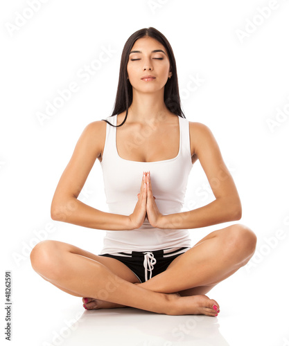 Photo: Young woman sitting in lotus position Young woman sitting in lotus position