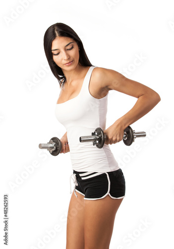 Photo: Cute fitness girl working out with dumbbells Cute fitness girl working out with dumbbells