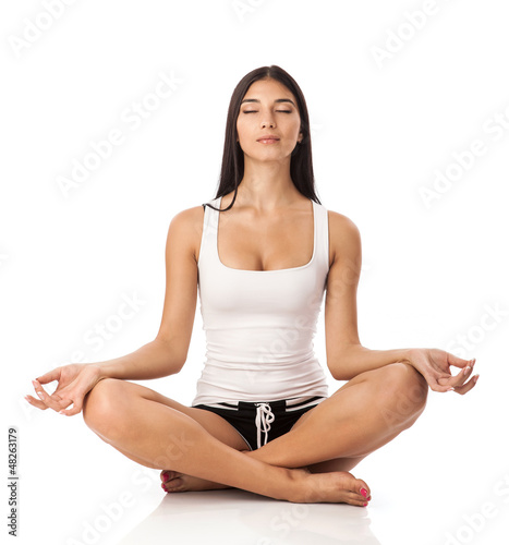 Photo: Young woman sitting in lotus position Young woman sitting in lotus position