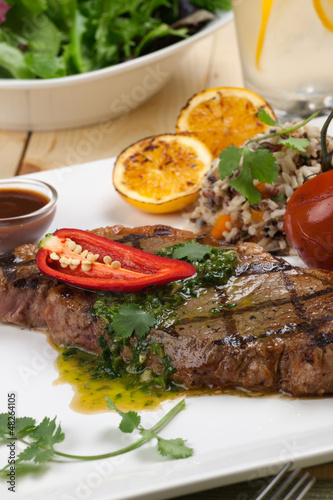 Photo: Piece of Medium Rare Steak with Spicy Herb Sauce Piece of Medium Rare Steak with Spicy Herb Sauce