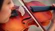 girl playing the violin in extremely close up shot