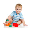 baby boy playing with toys, isolated over white