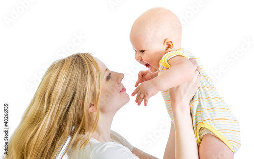 Photo: joyful mother playing with her baby infant joyful mother playing with her baby infant