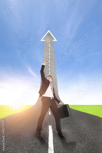 Photo: success businessman with the road rising up background success businessman with the road rising up background