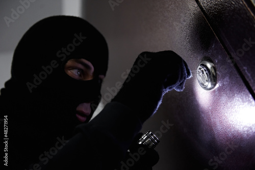 Photo: thief burglar at house breaking thief burglar at house breaking