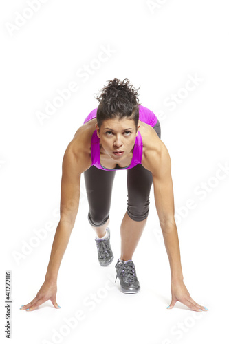 Photo: Muscular young woman ready to race in sports outfit Muscular young woman ready to race in sports outfit
