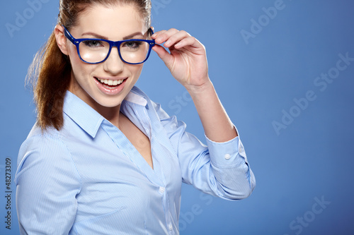 Photo: Portrait of happy smiling business woman in glasses Portrait of happy smiling business woman in glasses