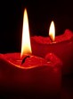 Red candles in front of a black background