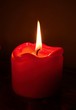 Red candles in front of a black background