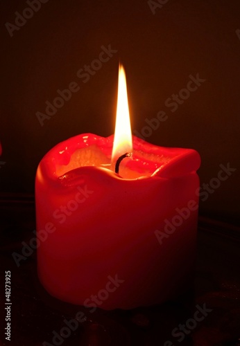 Photo: Red candles in front of a black background Red candles in front of a black background