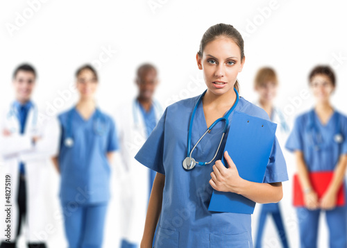 Photo: Nurse in front of her team Nurse in front of her team