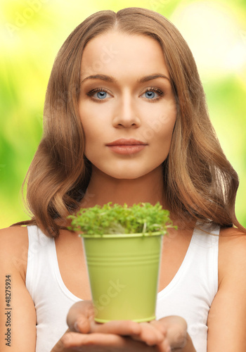 Photo: woman with green grass in pot woman with green grass in pot
