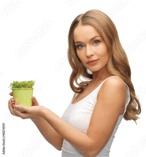 Photo: woman with green grass in pot woman with green grass in pot