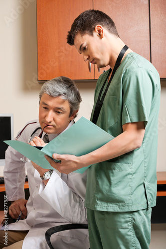 Photo: Technician Showing Report To Doctor Technician Showing Report To Doctor
