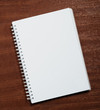 Notebook on wood background.