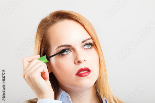 Photo: Woman applying mascara Woman applying mascara
