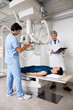 Radiologists Performing X-ray On Patient