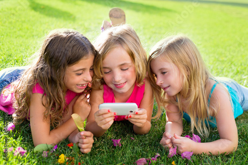 Photo: children friend girls playing internet with smartphone children friend girls playing internet with smartphone