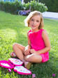 child kid girl playing with makeup set sitting in grass