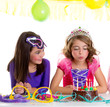 Photo: children happy girls blowing birthday party cake children happy girls blowing birthday party cake