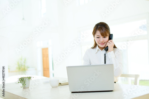 Photo: Beautiful asian businesswoman using a laptop computer Beautiful asian businesswoman using a laptop computer