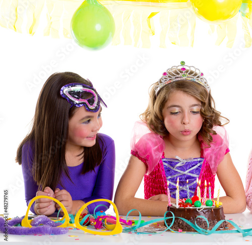 Photo: children happy girls blowing birthday party cake children happy girls blowing birthday party cake