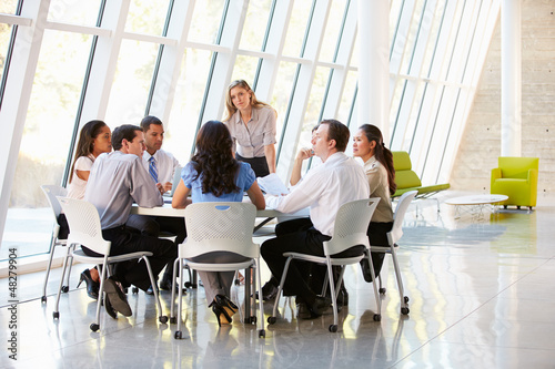 Photo: Business People Having Board Meeting In Modern Office Business People Having Board Meeting In Modern Office