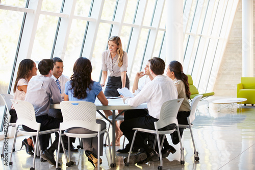 Photo: Business People Having Board Meeting In Modern Office Business People Having Board Meeting In Modern Office