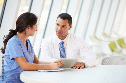 Photo: Doctor And Nurse Having Informal Meeting In Hospital Canteen Doctor And Nurse Having Informal Meeting In Hospital Canteen
