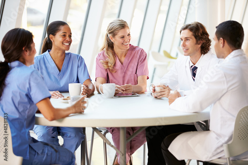 Photo: Medical Staff Chatting In Modern Hospital Canteen Medical Staff Chatting In Modern Hospital Canteen