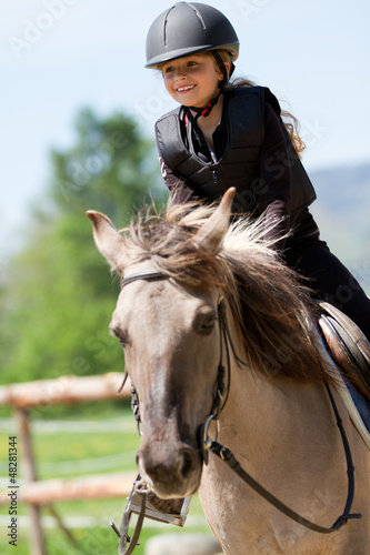 Photo: Horse riding - portrait of lovely equestrian on a horse Horse riding - portrait of lovely equestrian on a horse