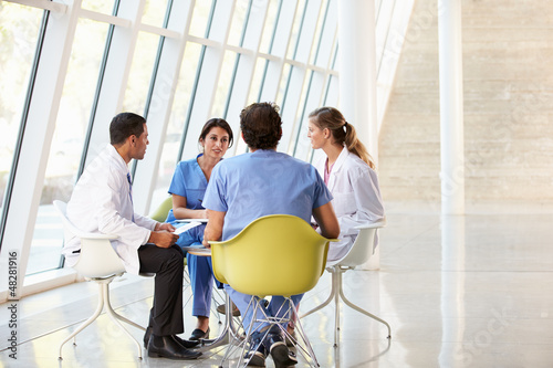 Photo: Medical Team Meeting Around Table In Modern Hospital Medical Team Meeting Around Table In Modern Hospital