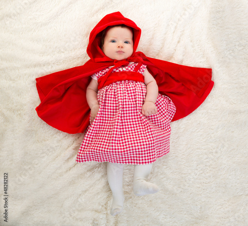 Photo: Baby Little Red Riding Hood on white fur Baby Little Red Riding Hood on white fur