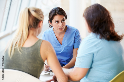Photo: Nurse Meeting With Teenage Girl And Mother In Hospital Nurse Meeting With Teenage Girl And Mother In Hospital