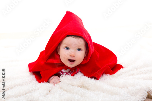 Photo: Baby Little Red Riding Hood on white fur Baby Little Red Riding Hood on white fur