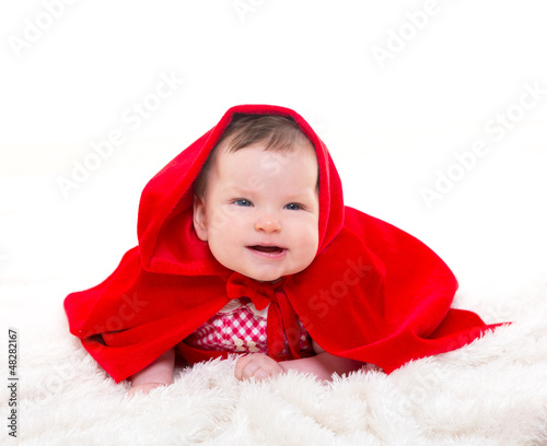 Photo: Baby Little Red Riding Hood on white fur Baby Little Red Riding Hood on white fur