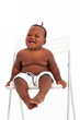cute african american baby boy sitting on chair