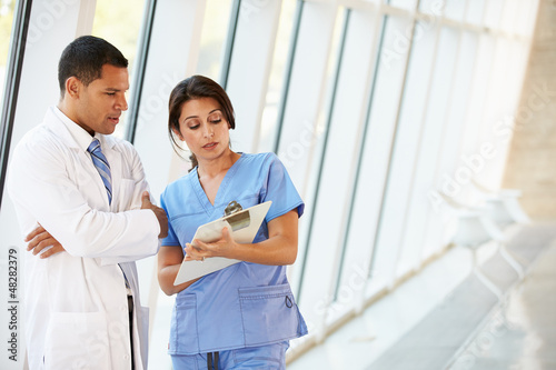 Photo: Medical Staff Having Discussion In Modern Hospital Corridor Medical Staff Having Discussion In Modern Hospital Corridor