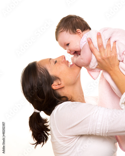 Photo: Baby girl hug in mother arms playingin happy on white Baby girl hug in mother arms playingin happy on white