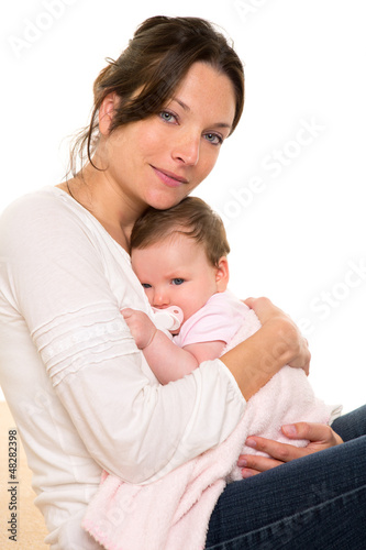 Photo: Baby girl relaxed with pacifier hug in mother arms Baby girl relaxed with pacifier hug in mother arms