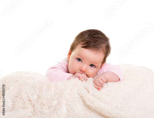 Photo: baby girl with toothache in pink with on white fur baby girl with toothache in pink with on white fur