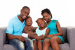 happy african american family sitting on sofa